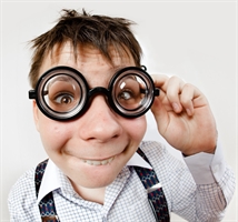 A boy wearing humorous coke-bottle spectacles. Taken with a fish-eye lense.