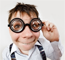A boy wearing humorous coke-bottle spectacles. Taken with a fish-eye lense. A boy wearing humorous coke-bottle spectacles. Taken with a fish-eye lense.
